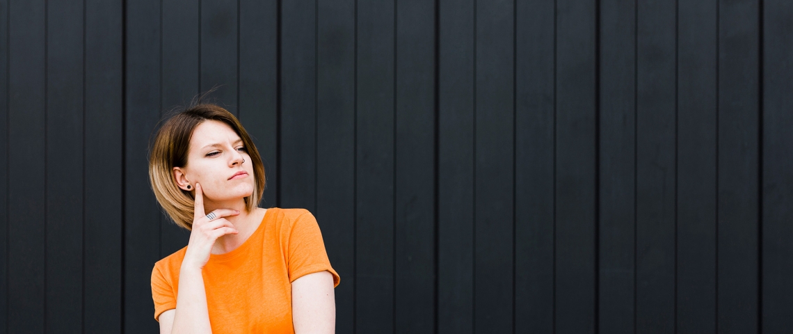 woman-standing-against-black-wall