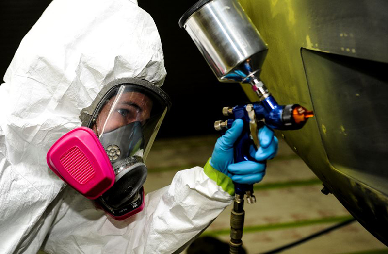 a person painting a vehicle